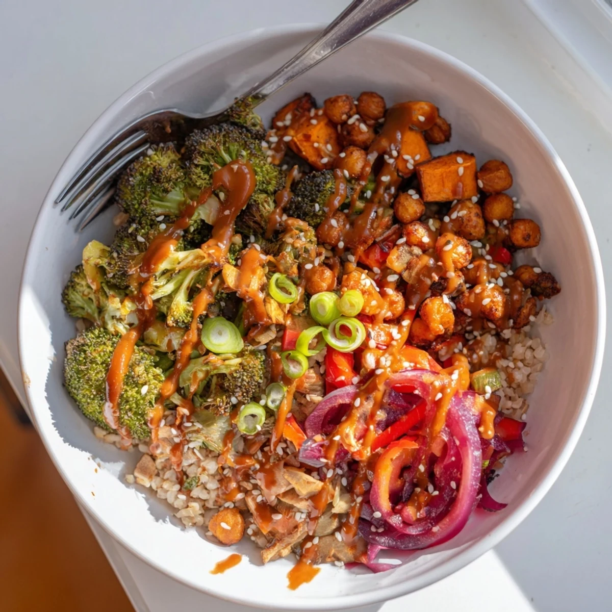 Vibrant Bold Sauce Drizzle Bowls topped with roasted vegetables and chickpeas, inviting flavors.  