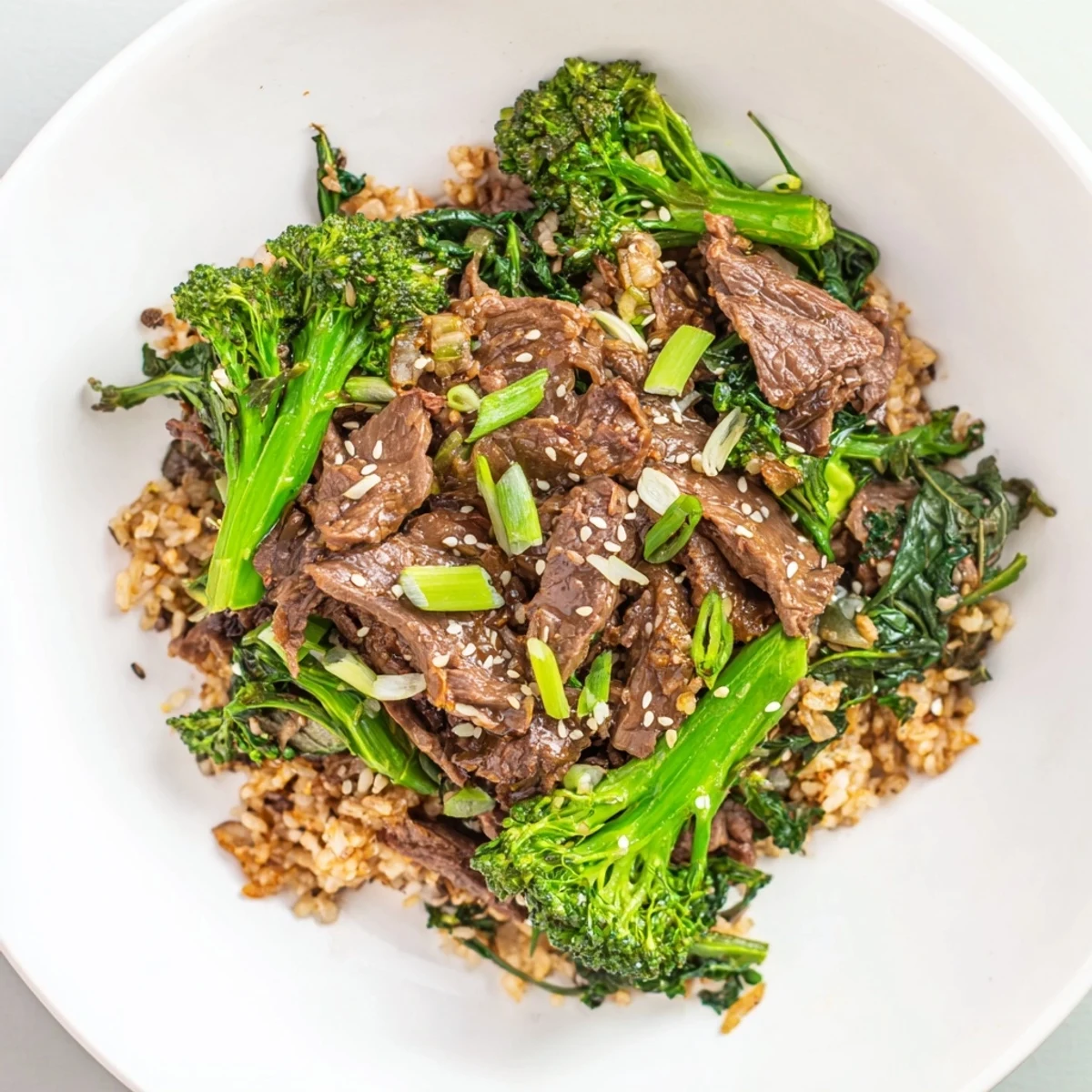 Tender Slow-Cooker Beef & Broccoli with a rich sauce, served over fluffy brown rice and fresh greens.