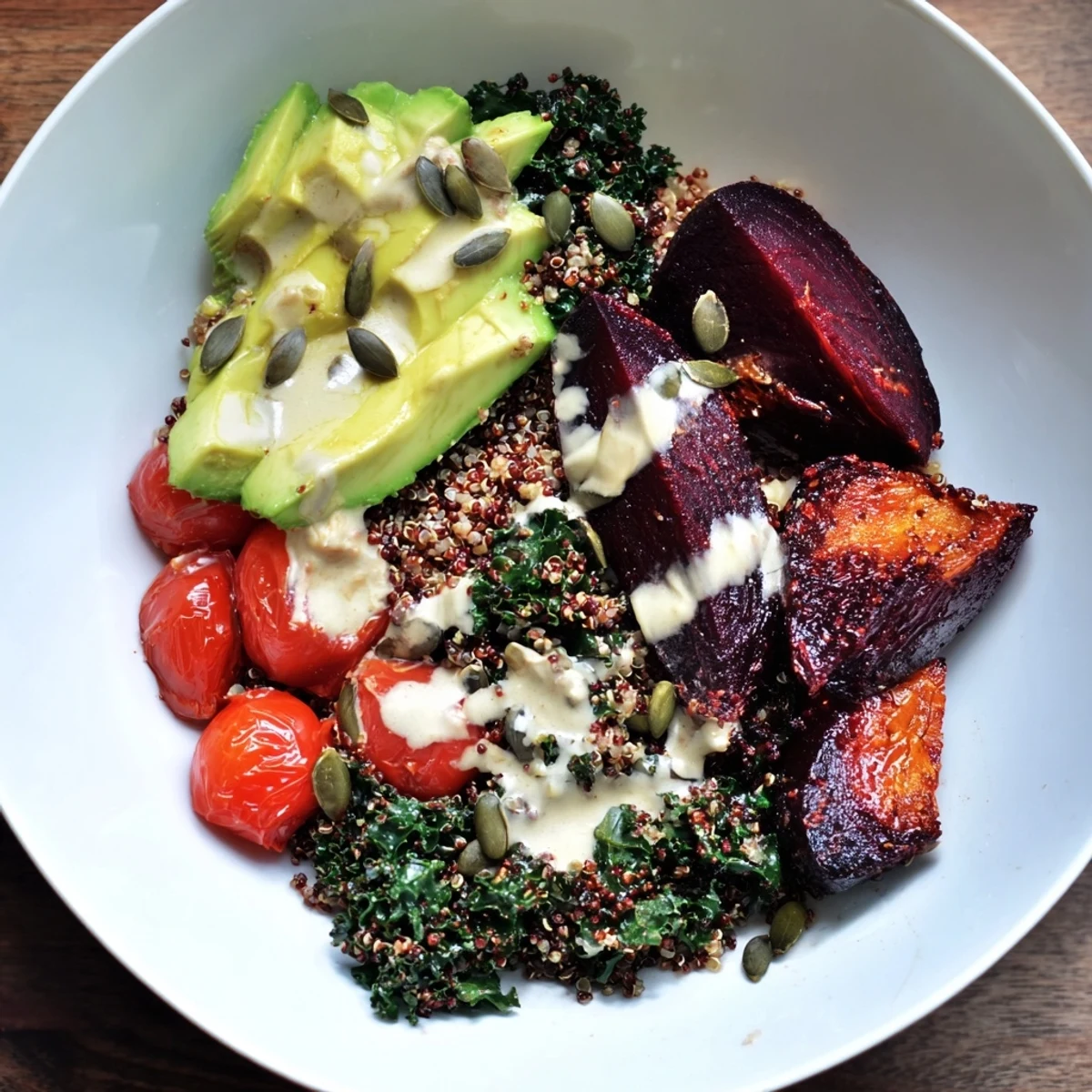 This healthy, gorgeous Quinoa, Kale & Roasted Beet Bowl features bright vegetables drizzled with tahini.