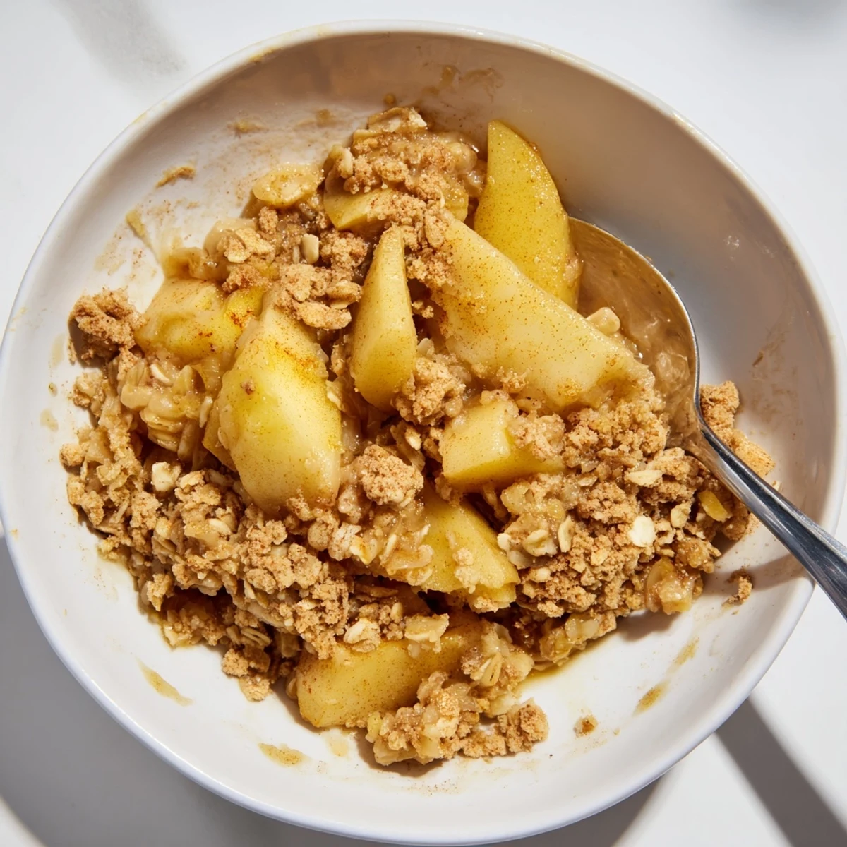 Warm Best Apple Crisp, a Thanksgiving favorite, served with a scoop of vanilla ice cream.