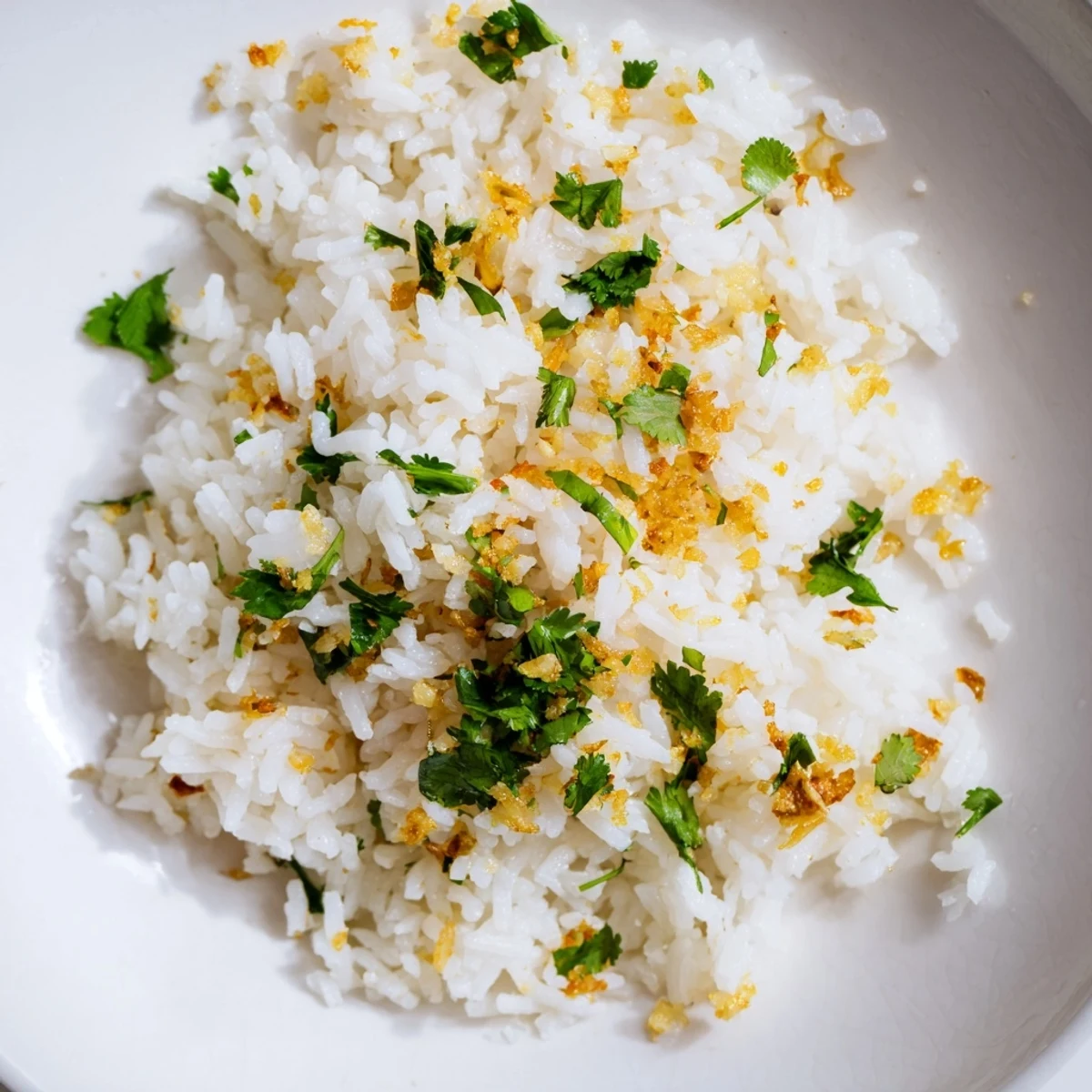 Steamed jasmine rice infused with aromatic garlic oil and garnished with scallions, perfect beside a colorful stir-fry.