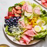 Vibrant Baby Shower Pastel Palette Salad, featuring artistically arranged pink, blue, and yellow ingredients.