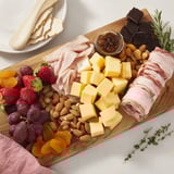 Beautifully arranged Anniversary Heirloom Arrangement features strawberries, chocolate, and aromatic rosemary garnishes.