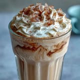 Creamy vanilla bean frappuccino protein shake with real vanilla and protein powder, blended until smooth and topped with whipped cream.