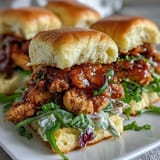 1. Juicy BBQ chicken sliders piled high with tangy coleslaw on soft slider buns, perfect for summer cookouts.