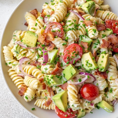 A beautifully presented BLT Pasta Salad, showing off crispy bacon and juicy tomatoes with pasta.