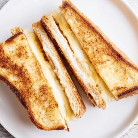 Golden Mayo Grilled Cheese with melted cheddar, perfect crust, served with tomato soup.