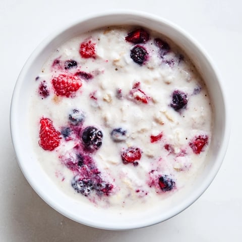 Creamy, swirled cottage cheese ice cream with mixed berries, a healthy and delightful dessert.