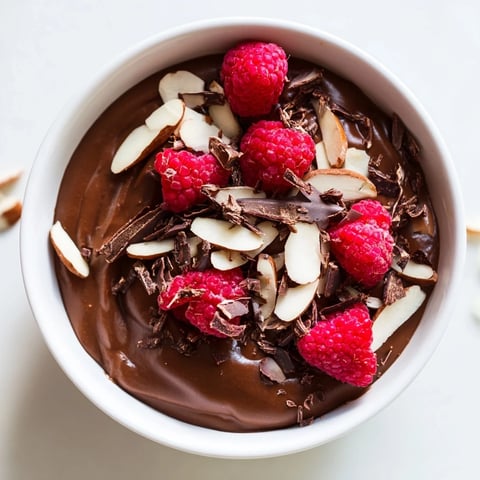 Silky-smooth Chocolate Avocado Mousse, topped with fresh berries, a decadent vegan dessert.