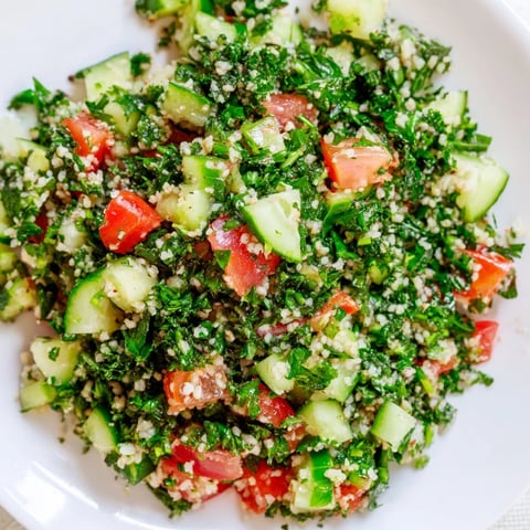 Vibrant Lebanese Tabbouleh salad bursting with fresh parsley and juicy tomatoes, ready to serve.