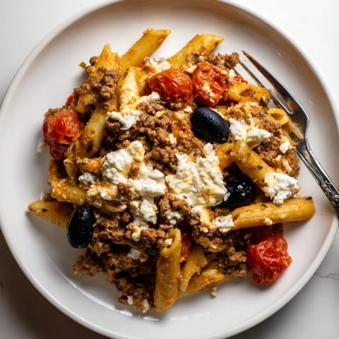 Golden crust on One-Pot Greek Gyro Pasta Bake with feta and fresh tomatoes.  