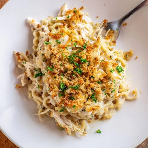 Creamy garlic-Parmesan sauce envelops tender ramen and shredded chicken in this bake.  