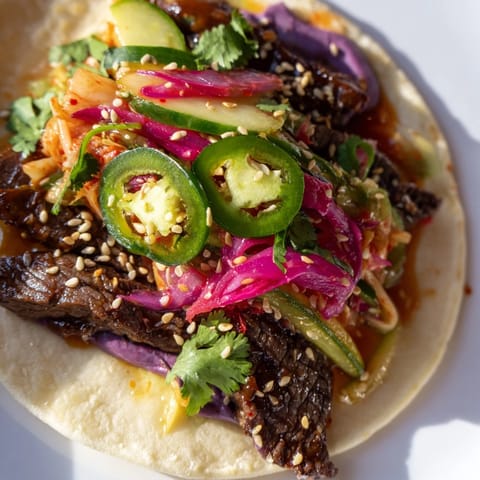 Savory Korean bulgogi tacos bursting with flavor, drizzled with creamy ube sauce.  