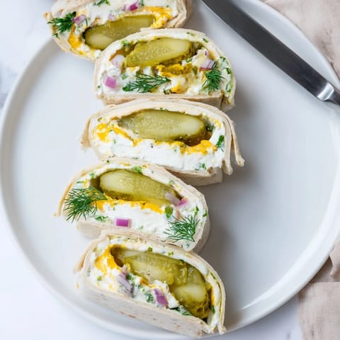 Delicious Pickle-in-a-Blanket featuring tangy dill pickles and creamy cheese wrapped warmly.  