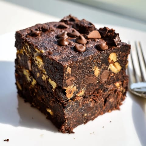 Deliciously gooey brownies made with nut-milk pulp for sustainable dessert enjoyment.  