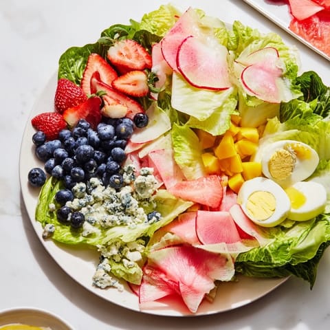 Vibrant Baby Shower Pastel Palette Salad, featuring artistically arranged pink, blue, and yellow ingredients.