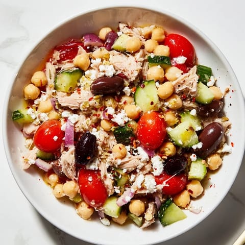 Fresh, flavorful tuna chickpea salad: imagine the bright red tomatoes and fresh parsley mixed with tuna.