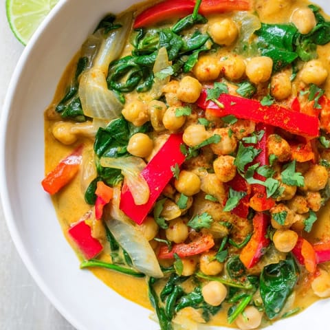 A vibrant bowl of Chickpea Curry with tender vegetables, rich coconut milk, and fragrant spices.