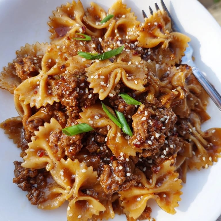 Comforting Korean BBQ Beef Bowtie Pasta with crunchy scallions and toasted seeds.