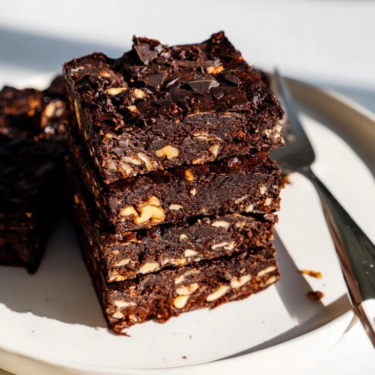 Indulgent zero-waste brownies topped with nuts, perfect for a sweet, eco-friendly treat.