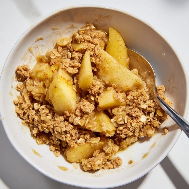 Warm Best Apple Crisp, a Thanksgiving favorite, served with a scoop of vanilla ice cream.
