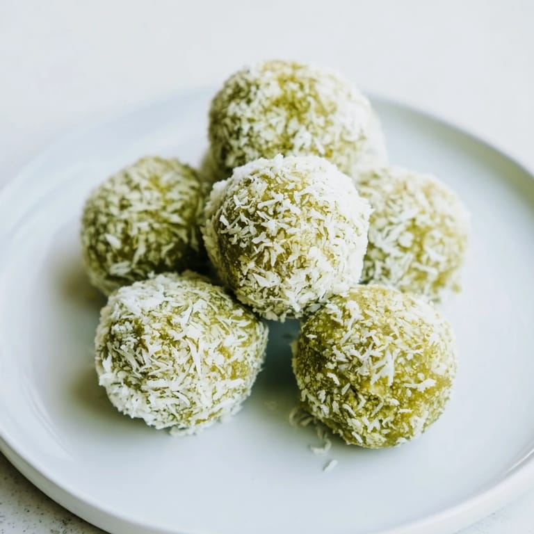 These vibrant green Coconut Matcha Snowball fat bombs offer a unique blend of flavors, ready to enjoy.