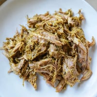 Tender Omani Shuwa, fragrant with spices, is draped in banana leaves, ready for slow cooking.