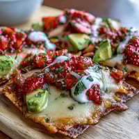 A colorful Summer Party Nacho Board with crispy tortilla chips, melted cheese, and fresh strawberry salsa for a festive appetizer.