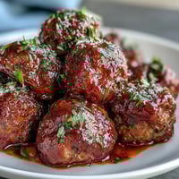 Juicy slow cooker meatballs simmering in rich tomato sauce, perfect for easy entertaining and crowd-pleasing appetizers.  