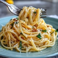 Spring Pasta Limone with lemon butter sauce, parmesan, and basil in a creamy, glossy finish.